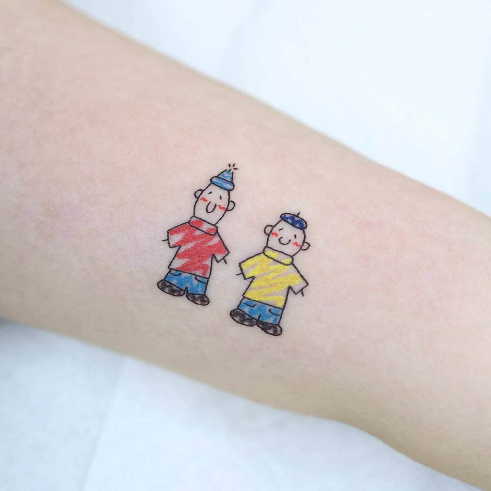 Pat & Mat tattoo in cartoon style located on the upper arm.