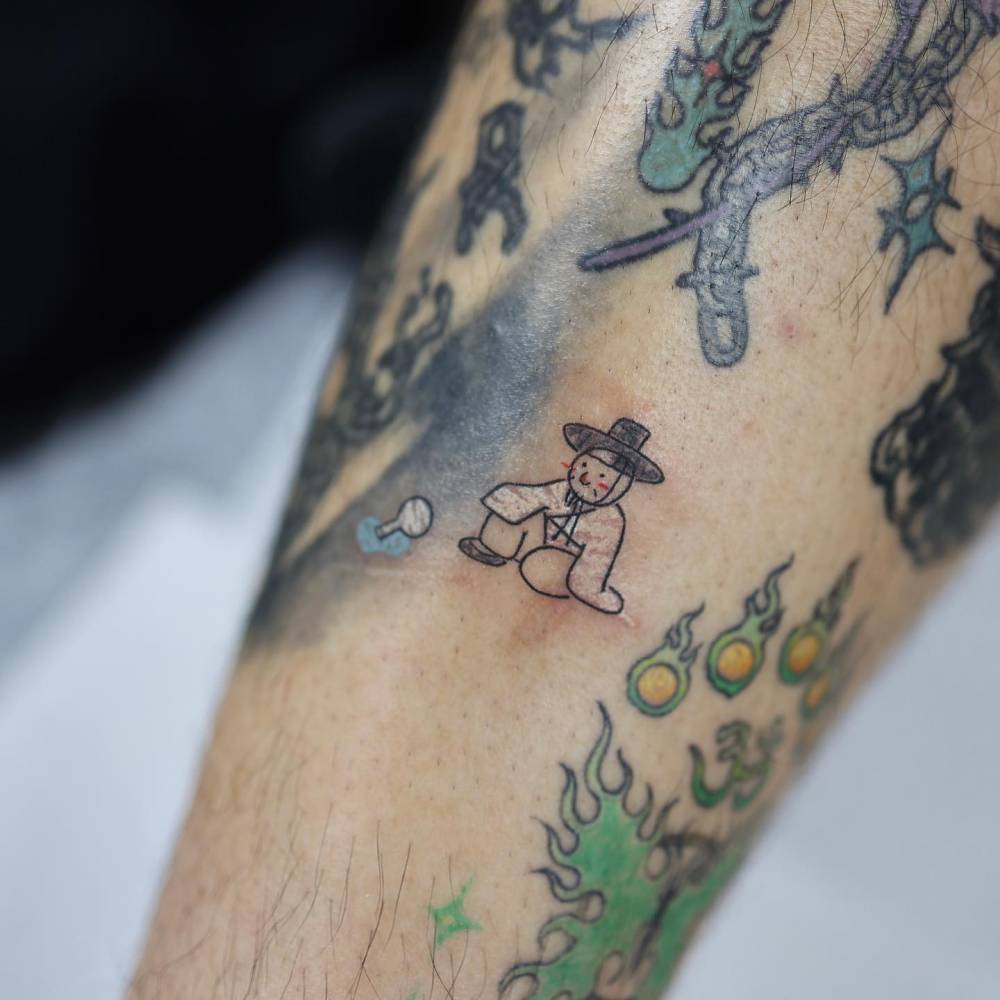 Korean figure tattoo in cartoon style located on the shin.