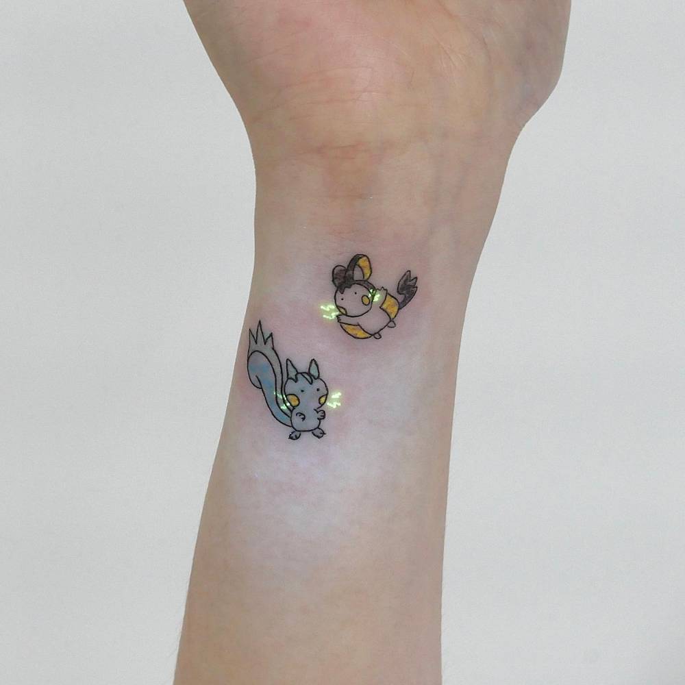 Emolga and Pachirisu tattooed on the wrist, cartoon style.