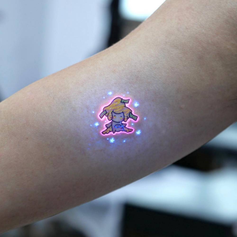 Jirachi tattoo in cartoon style located on the inner forearm.
