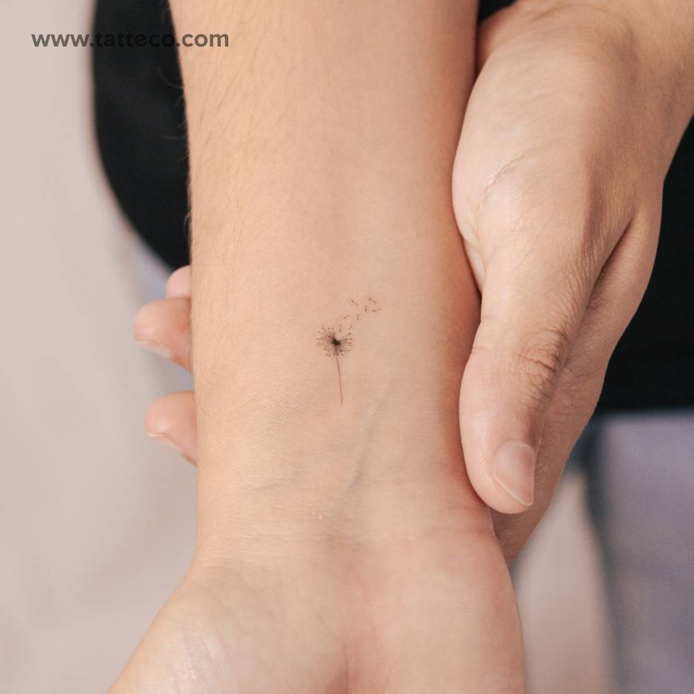 Semi-permanent fine line dandelion tattoo placed on the wrist.