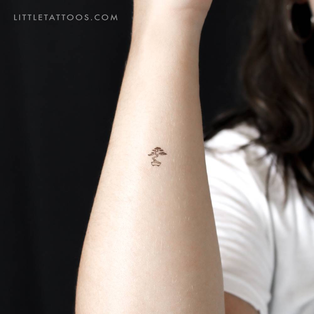Tiny fine line style bonsai temporary tattoo located on the wrist.