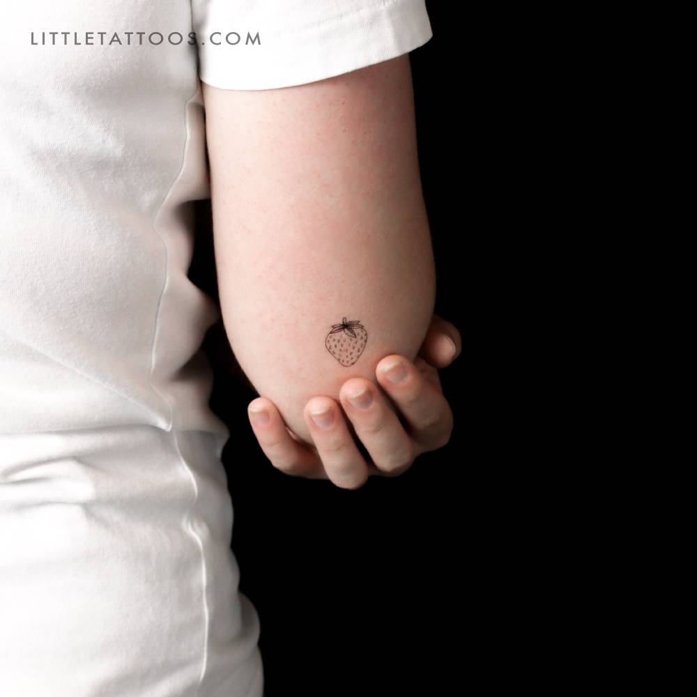 Strawberry temporary tattoo in fine line style.