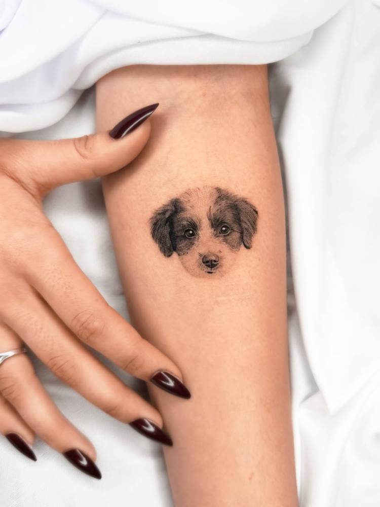 Dog portrait tattoo located on the inner forearm, micro-realistic style.