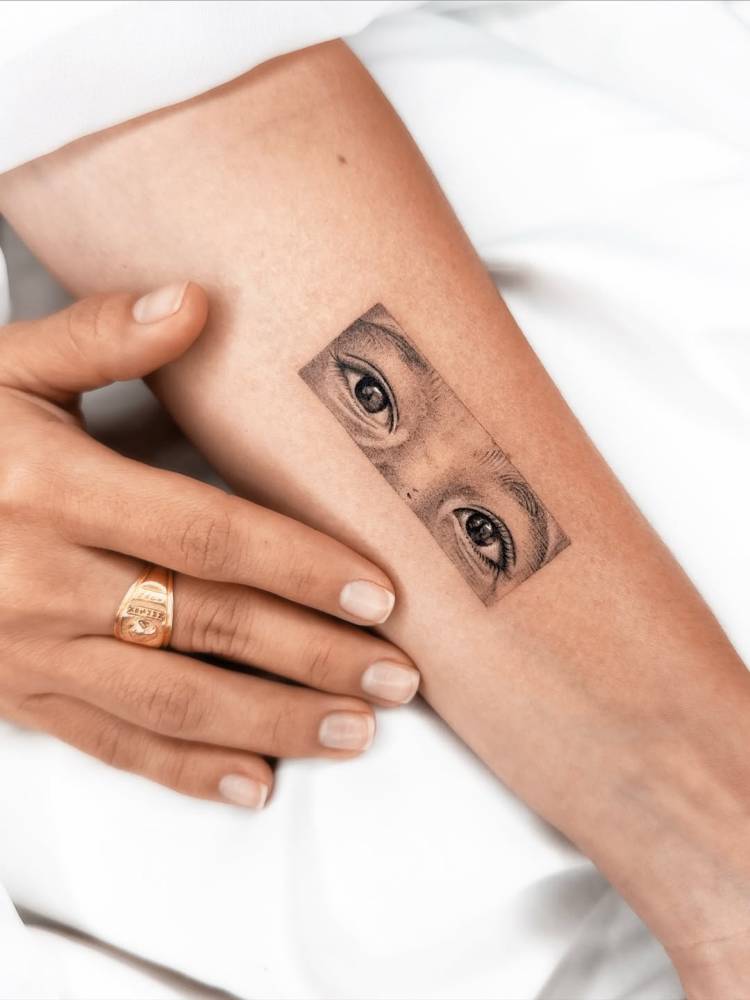 Eyes tattoo done on the inner forearm, micro-realistic style.
