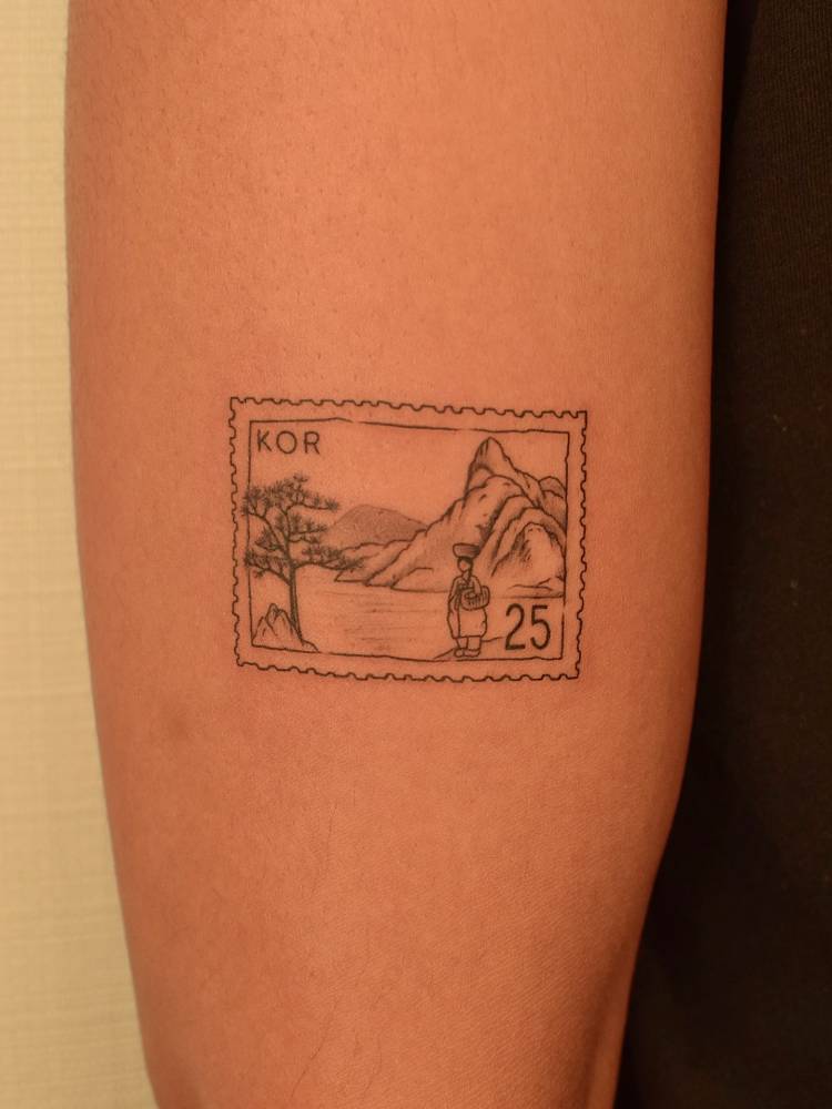 Korean stamp tattoo located on the upper arm.