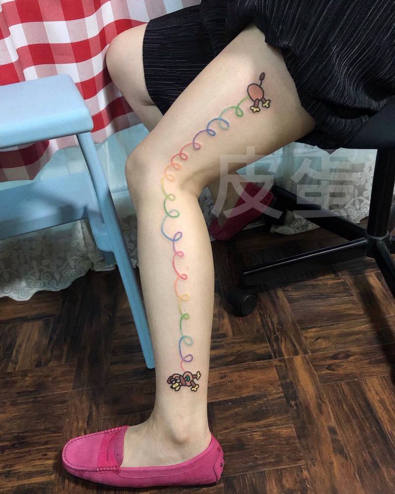Slinky Dog tattoo in cartoon style located on the leg.