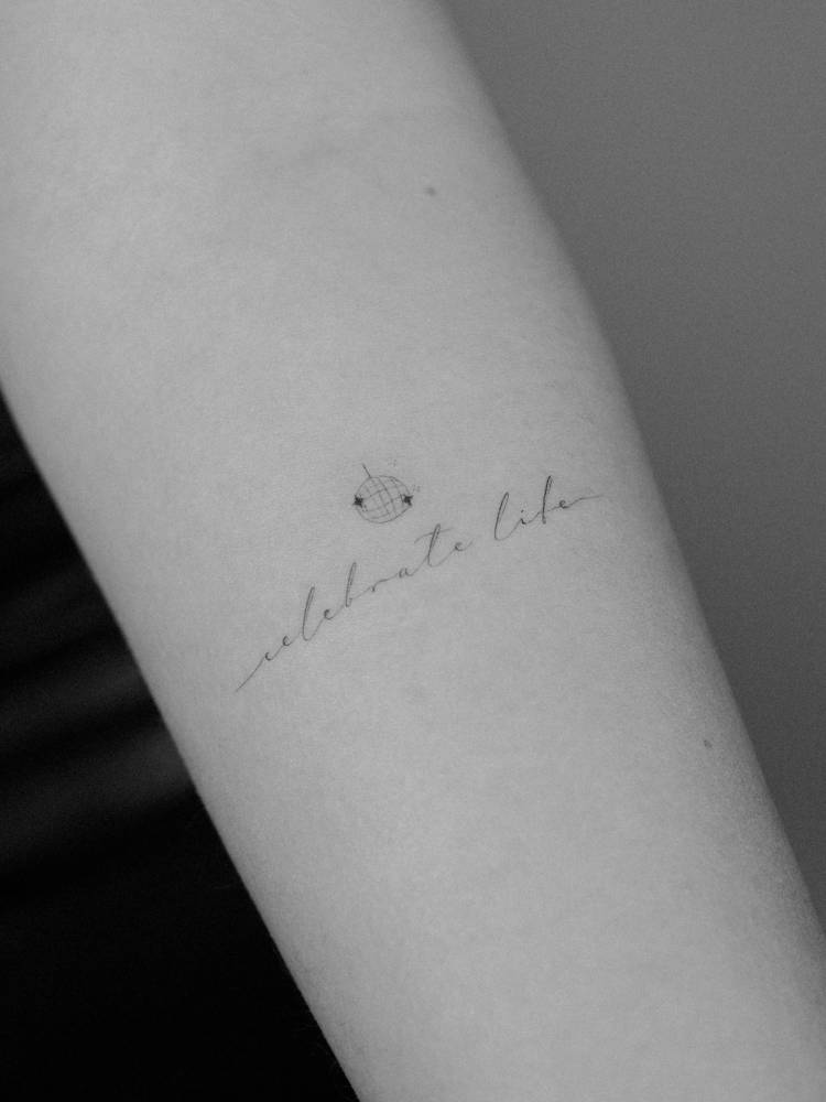 Celebrate life and minimalistic disco ball tattooed on the inner forearm.