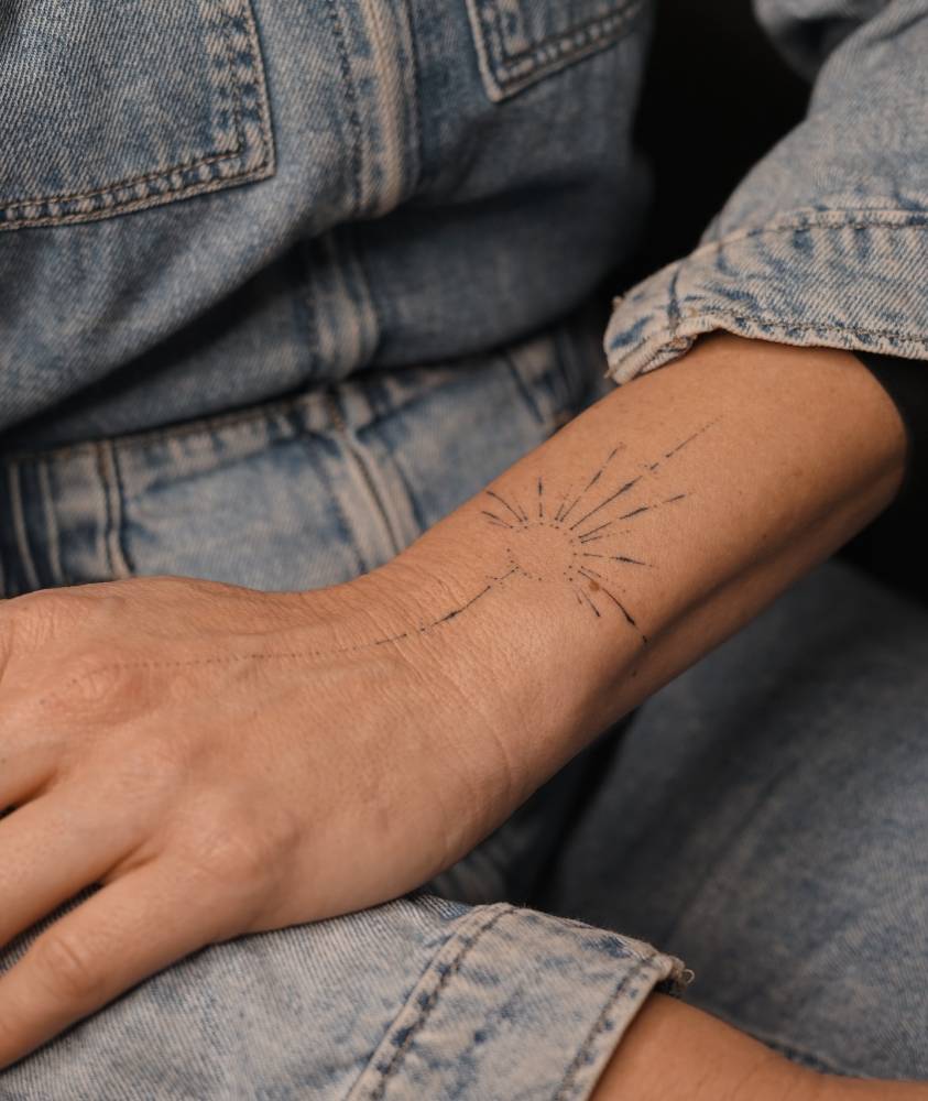 Hand poked ornamental design tattooed on the wrist.