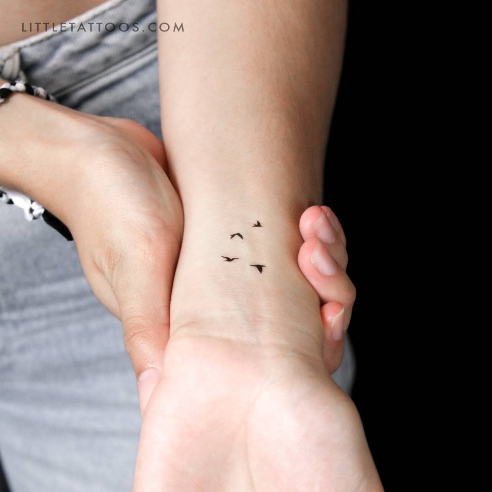 Small flying birds temporary tattoo located on the wrist.