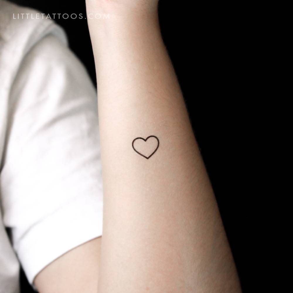 Small heart outline temporary tattoo located on the wrist.
