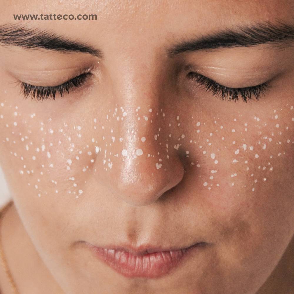 White freckles temporary tattoo located on the face.