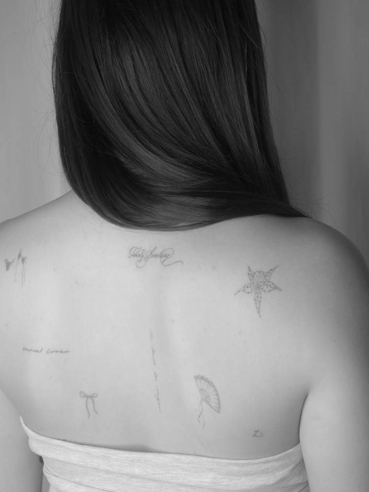 Back composition tattoos in fine line style.