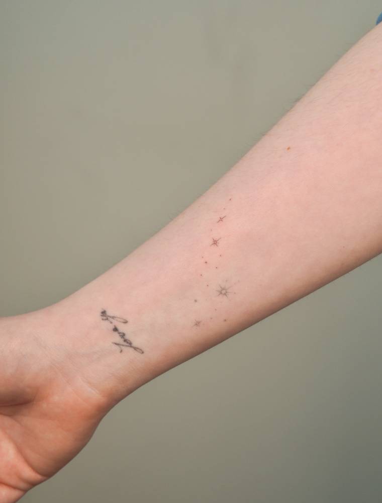 Sparking stars tattoo in minimalistic style located on the wrist.