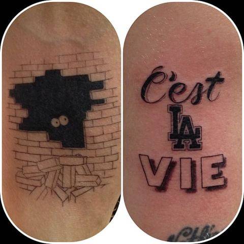 Brick wall and "C'est la vie" tattoos.