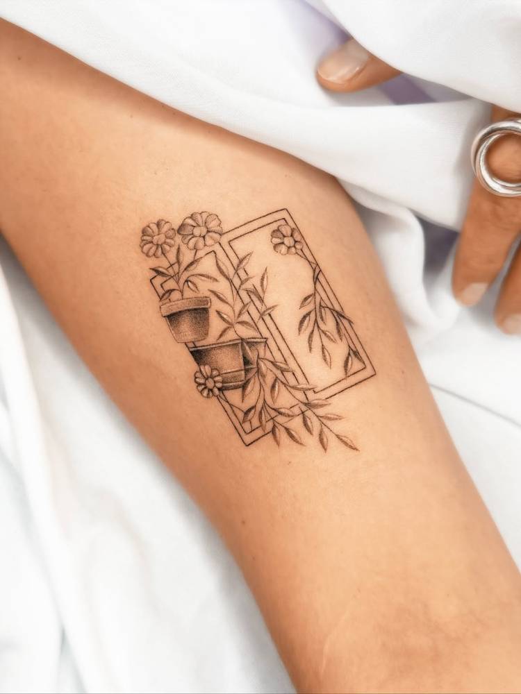 Window and flower pots tattooed on the bicep.