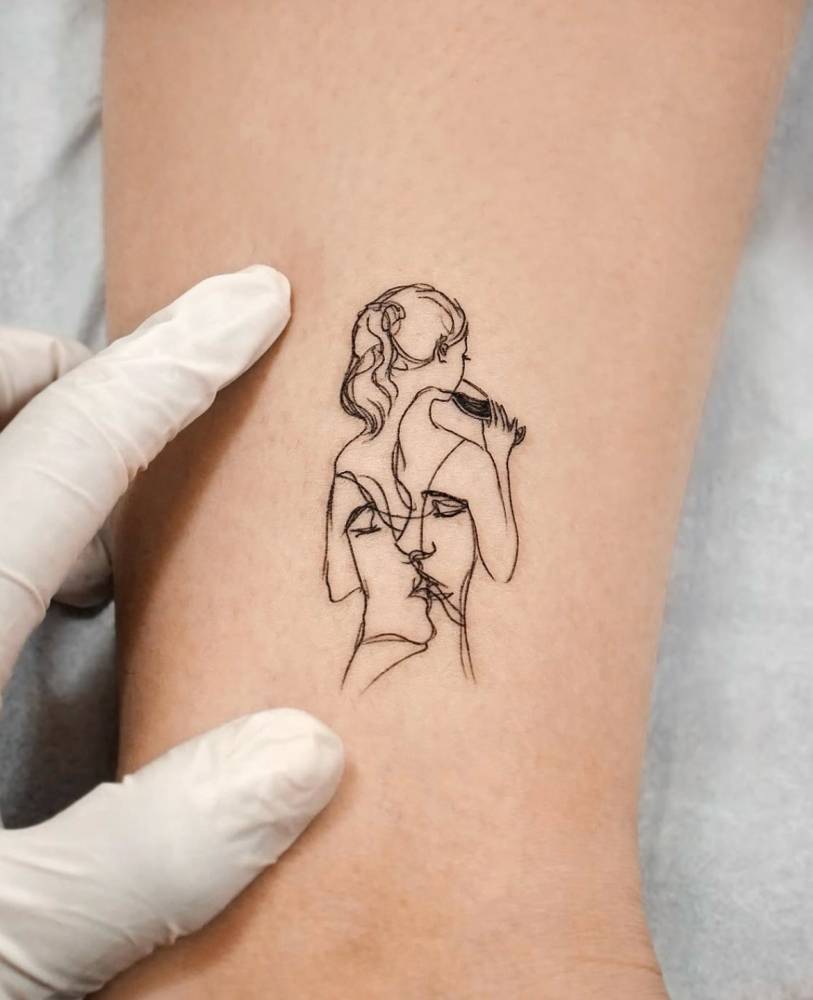 Wine drinking and kiss tattoo located on the wrist, sketch work style.