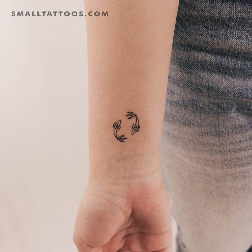 Two opposite fish temporary tattoo located on the wrist.