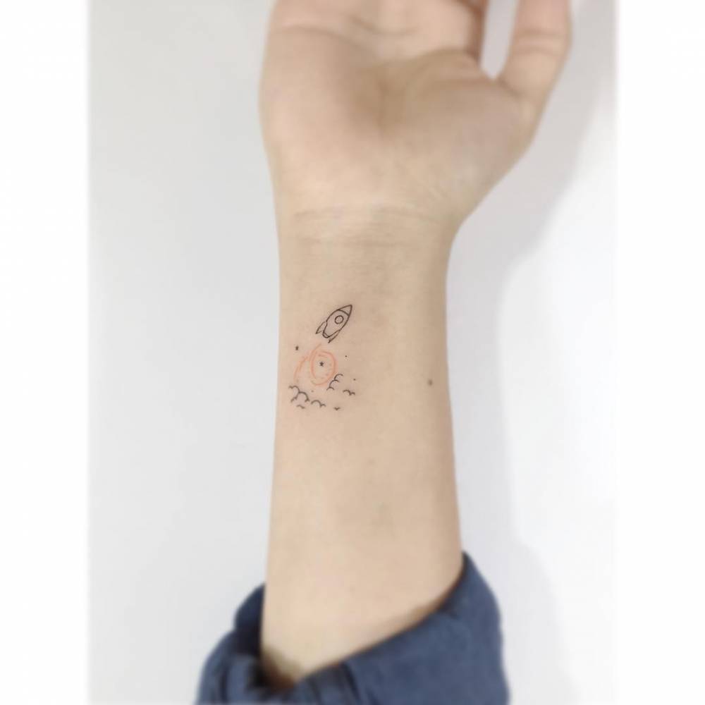 Minimalistic style rocket tattoo placed on the wrist.