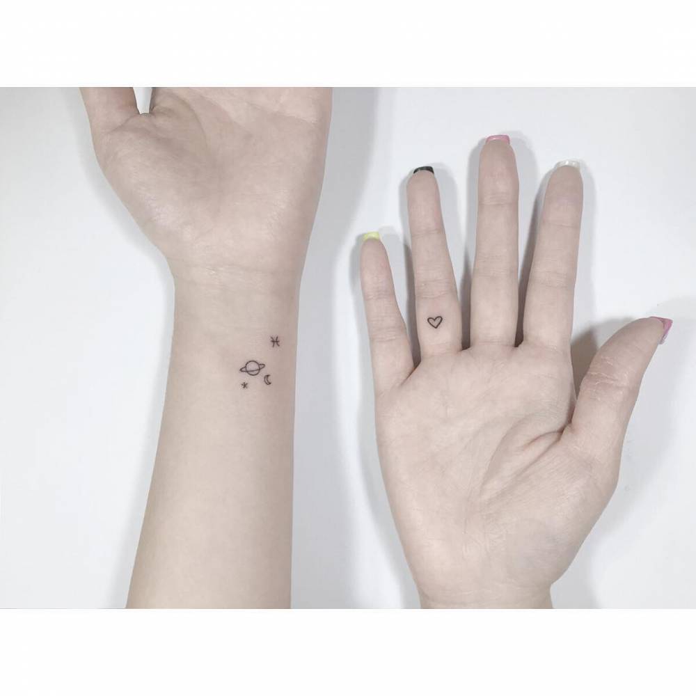 Minimalistic style galaxy and heart tattoos.