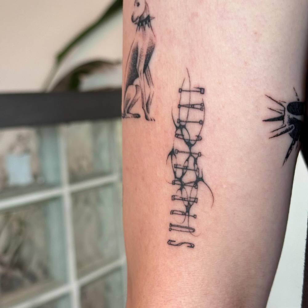 "Superficial" lettering tattoo done on top of old tattoo.