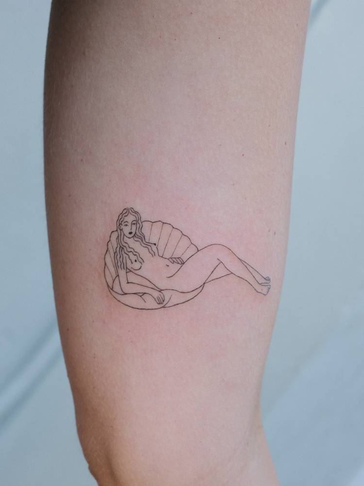 Venus tattoo located on the inner arm, fine line style.