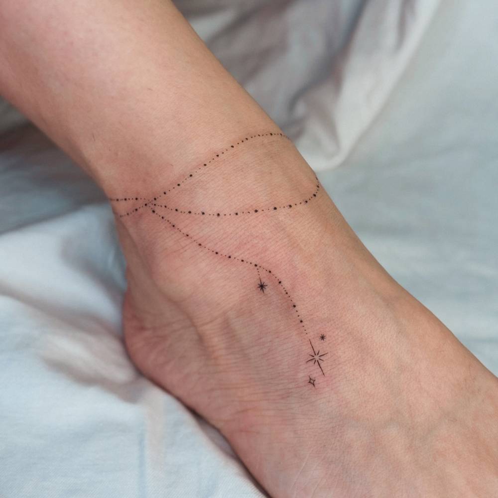 Ornamental ankle band tattoo in fine line style.