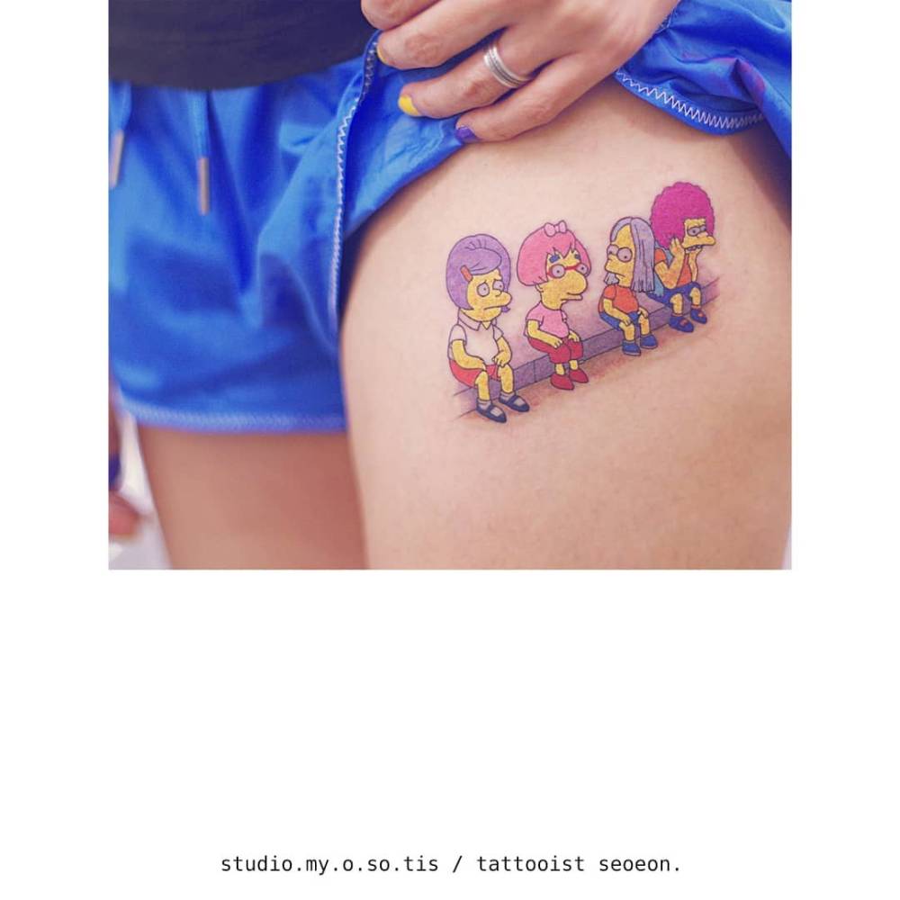 The Simpsons tattoo in cartoon style located on the thigh.