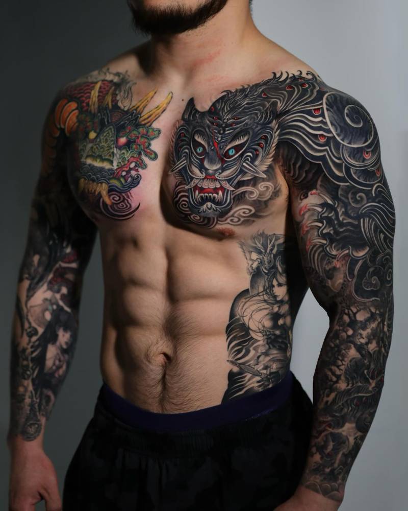 Oriental style tiger tattoo located on the chest and shoulder.