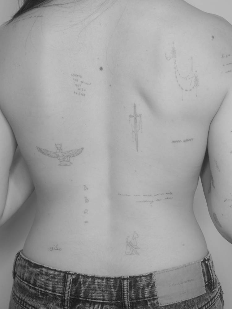 Fine line style back composition tattoos.