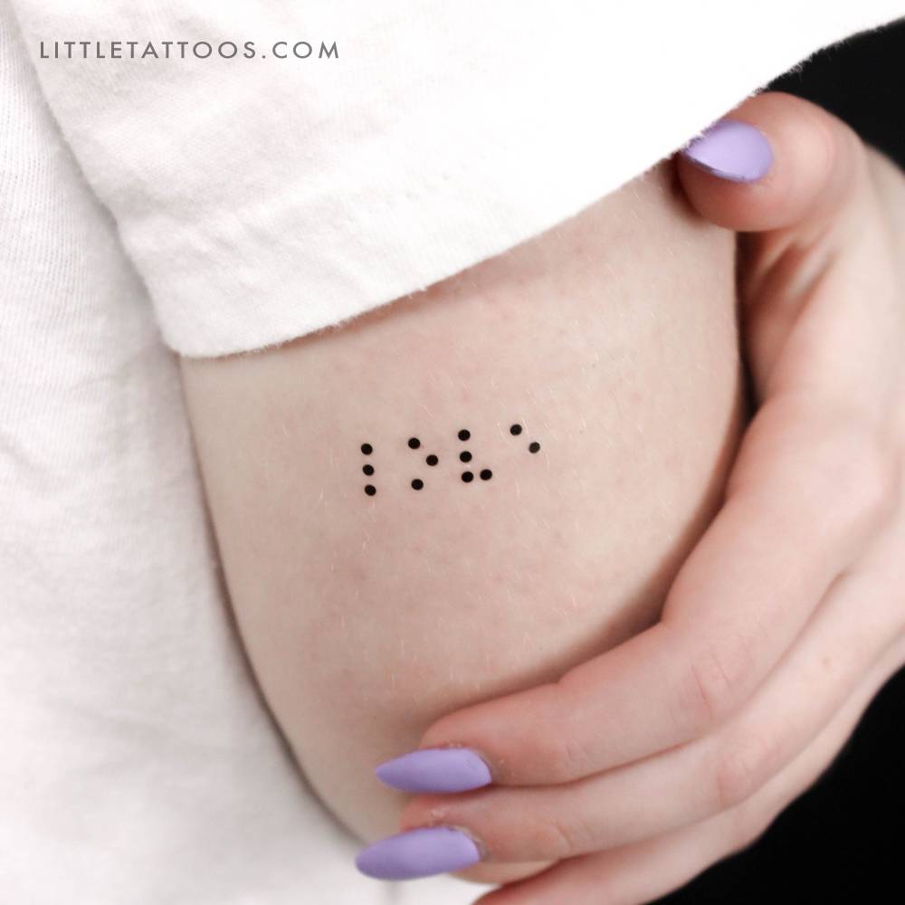 Braille "Love" temporary tattoo located on the tricep.
