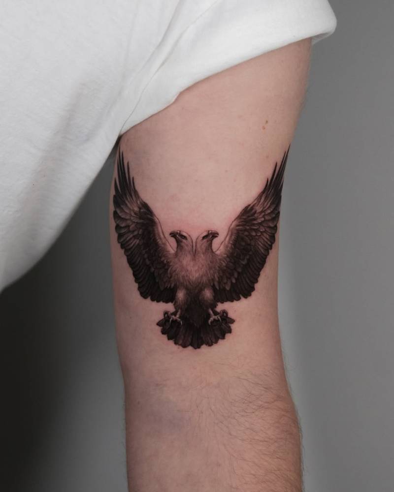 Double-headed eagle tattoo in micro-realistic style done on the bicep.