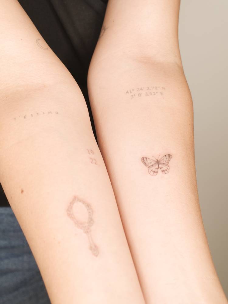 Butterfly tattoo in fine line style located on the inner forearm.