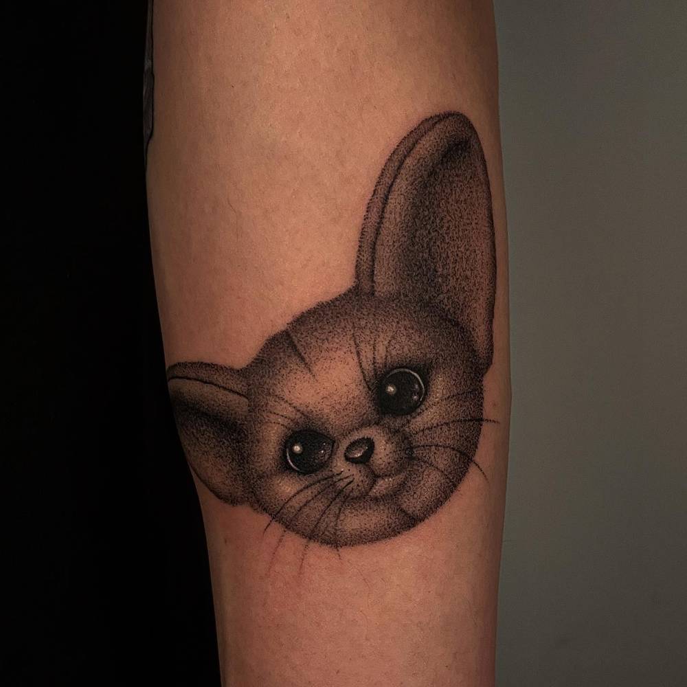Fennec fox portrait tattoo located on the inner forearm.