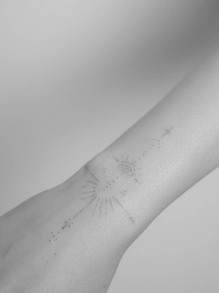 Ornamental evil eye tattoo located on the wrist.