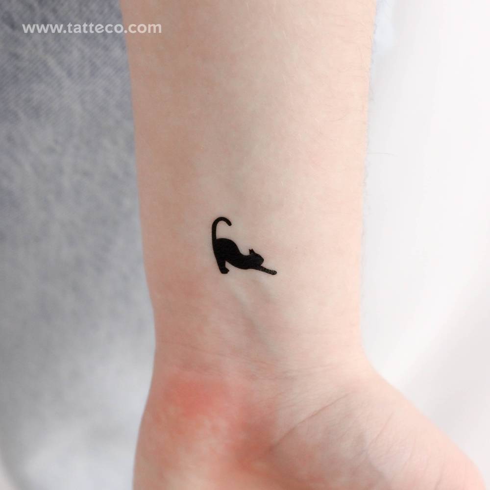Black stretching cat temporary tattoo located on the wrist.