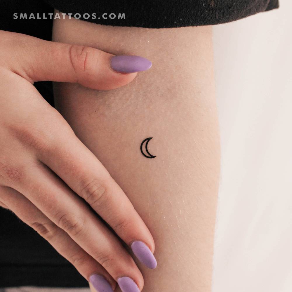 Moon planetary symbol temporary tattoo located on the inner forearm.