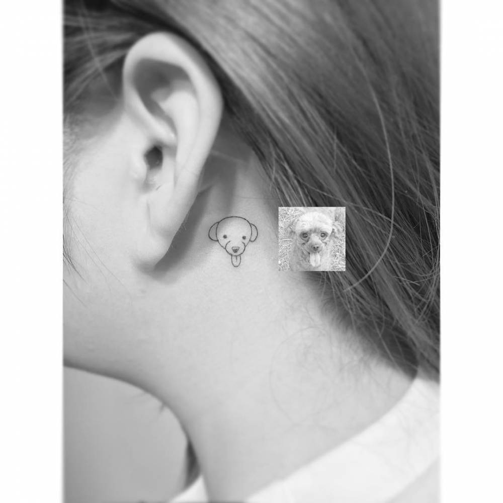 Dog portrait tattoo in minimalistic style placed behind the ear.