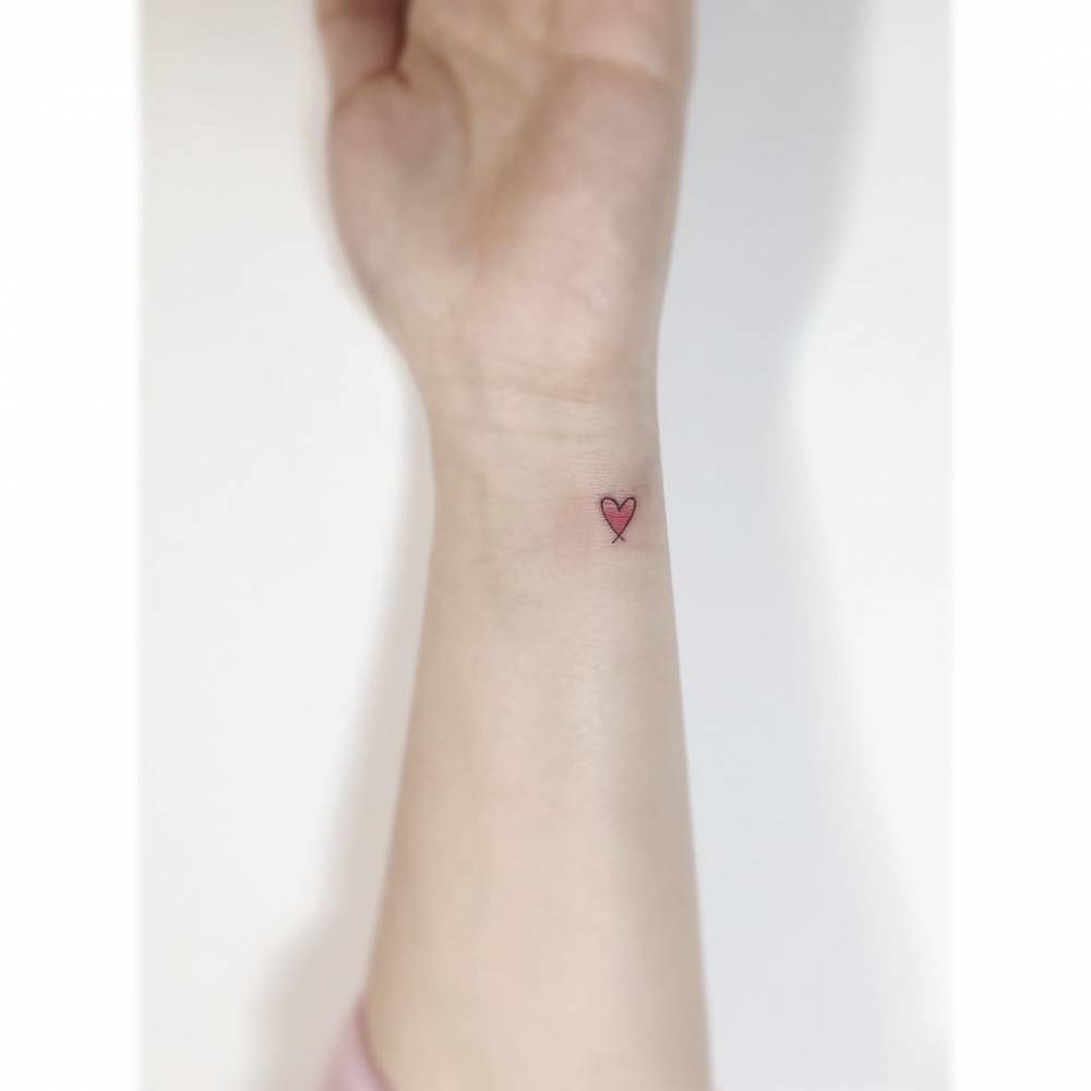 Little spectrum heart tattoo done on the wrist.