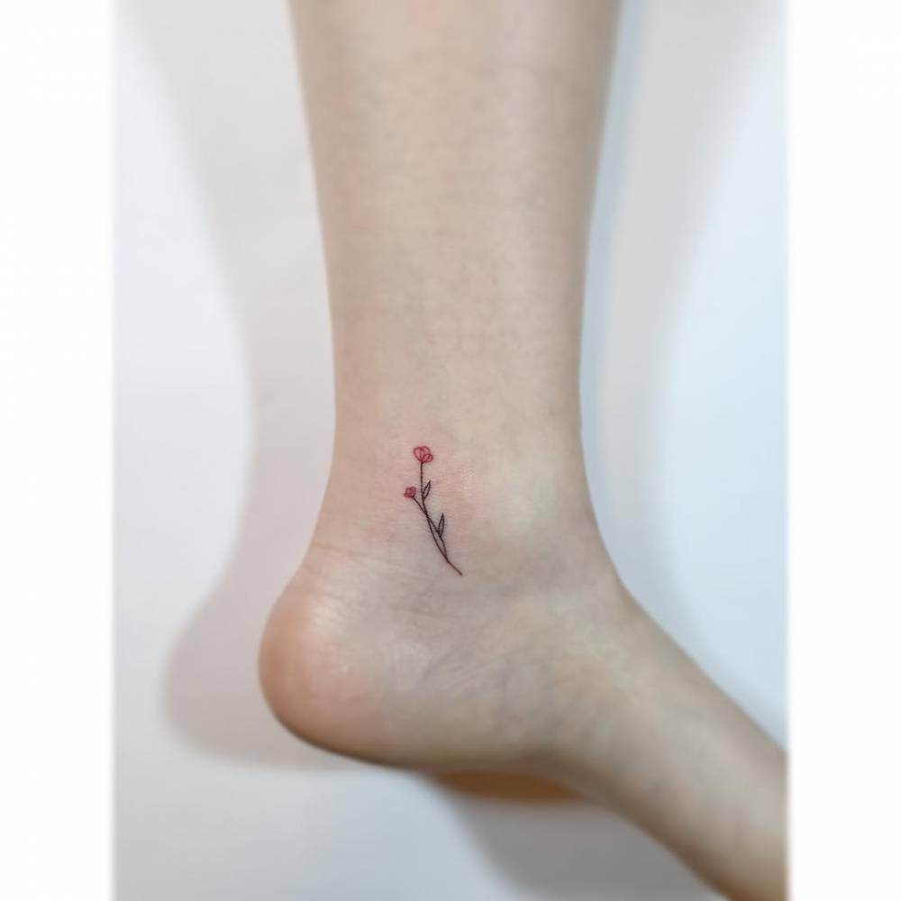 Flowers tattoo in minimalistic style located on the ankle.