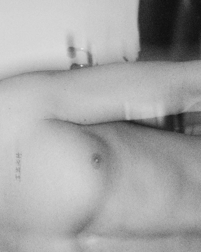 Alejandro Speitzer's chinese lettering chest tattoo.