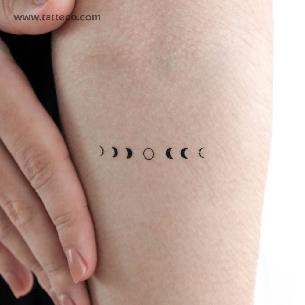 Moon phases temporary tattoo located on the inner forearm.