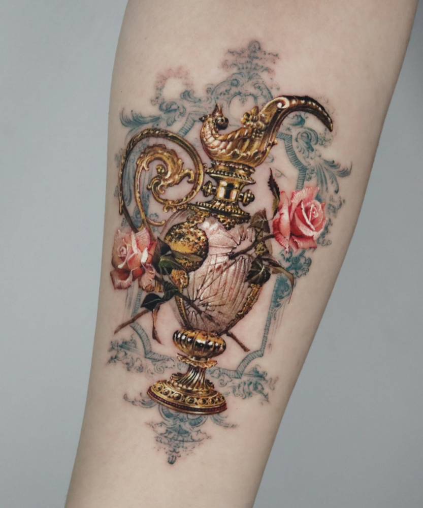 Vase and pink roses tattoo placed on the inner forearm.