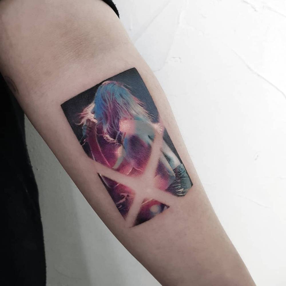 Singer tattoo in micro-realistic style located on the inner forearm.