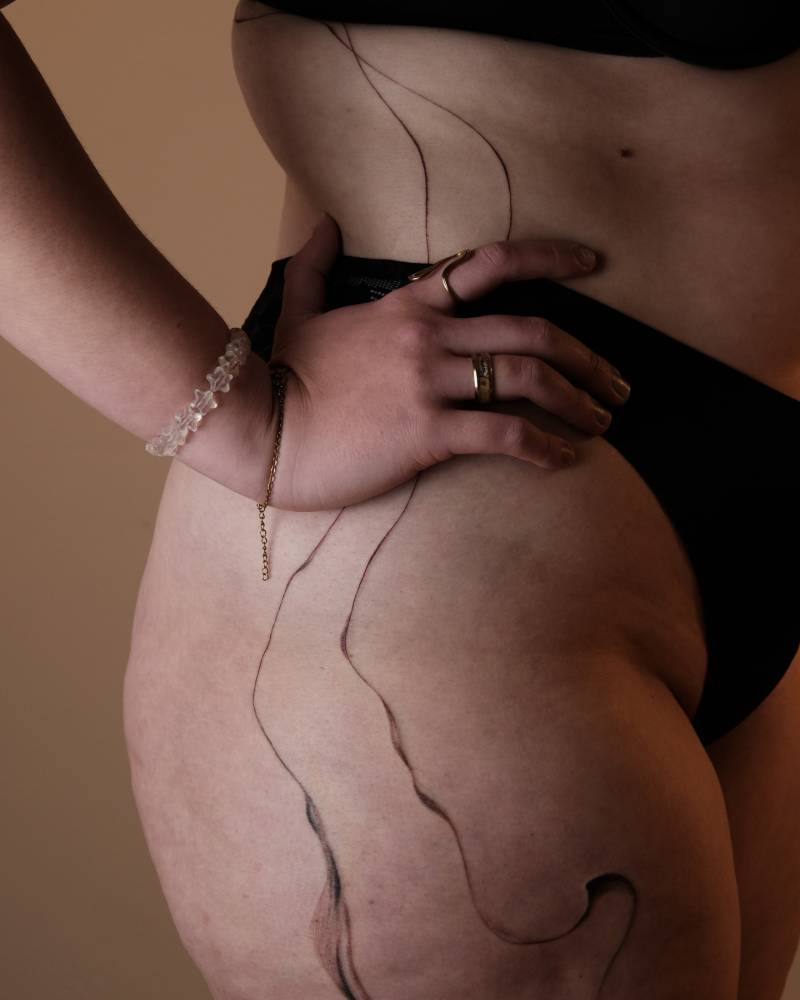 Abstract flowely lines tattooed on the hip and waist.