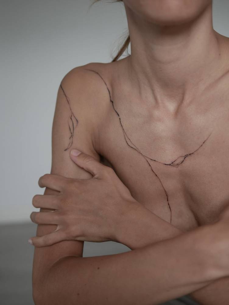 Leaves tattoo located on the shoulder and chest.