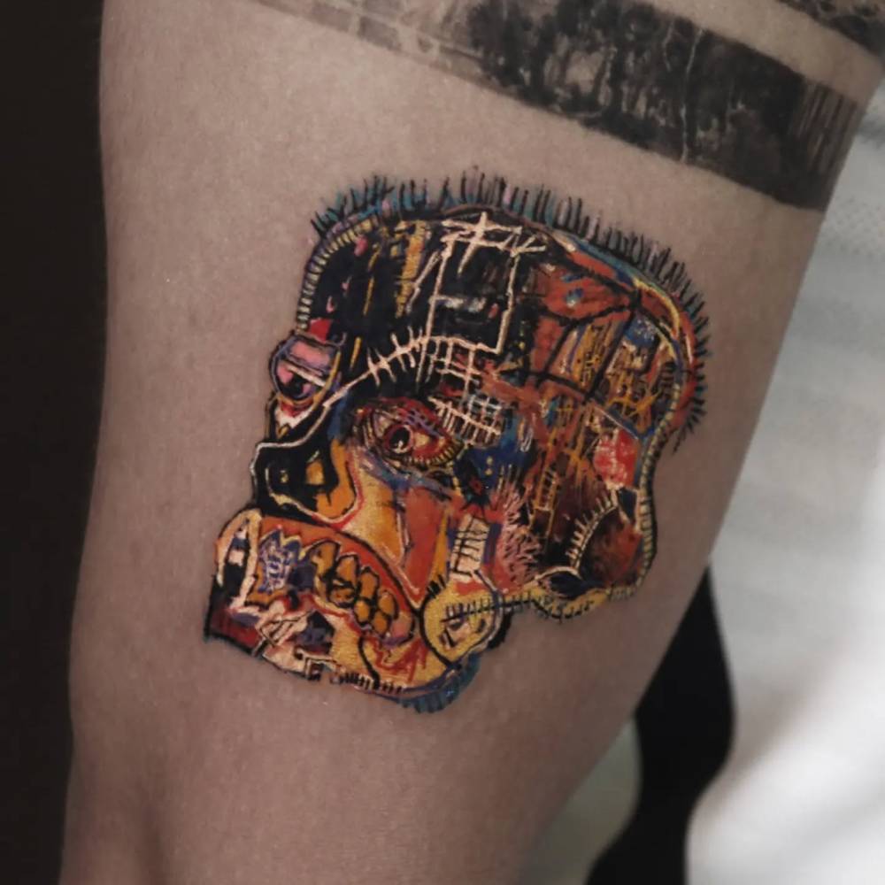 Jean-Michel Basquiat's untitled 1981 artwork tattooed on the upper arm.