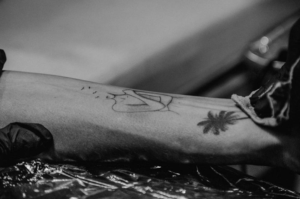 Self hug tattoo located on Barbara de Regil's inner forearm.