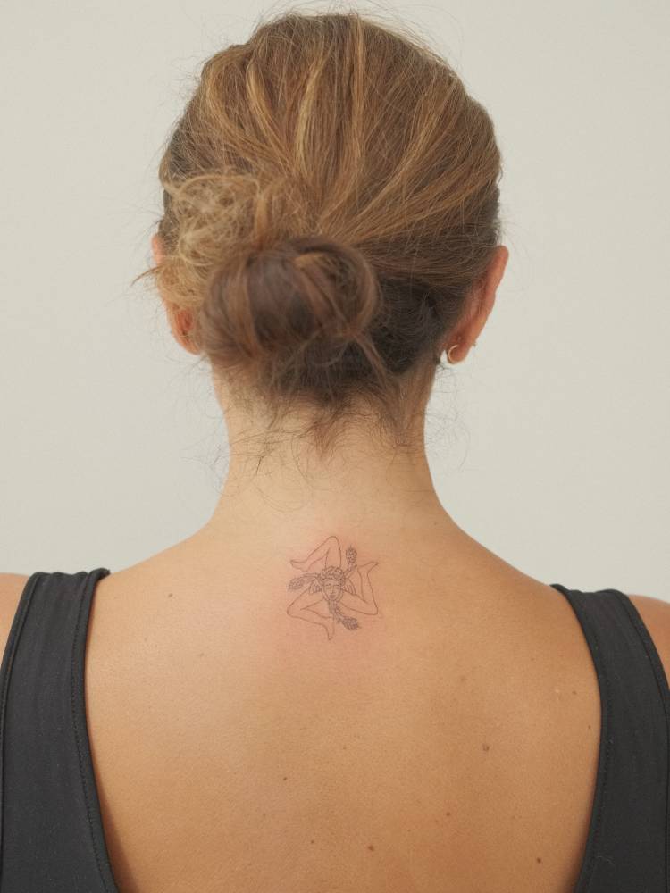 Sicilian flag Triskeles-with-Gorgoneion located on the upper back.