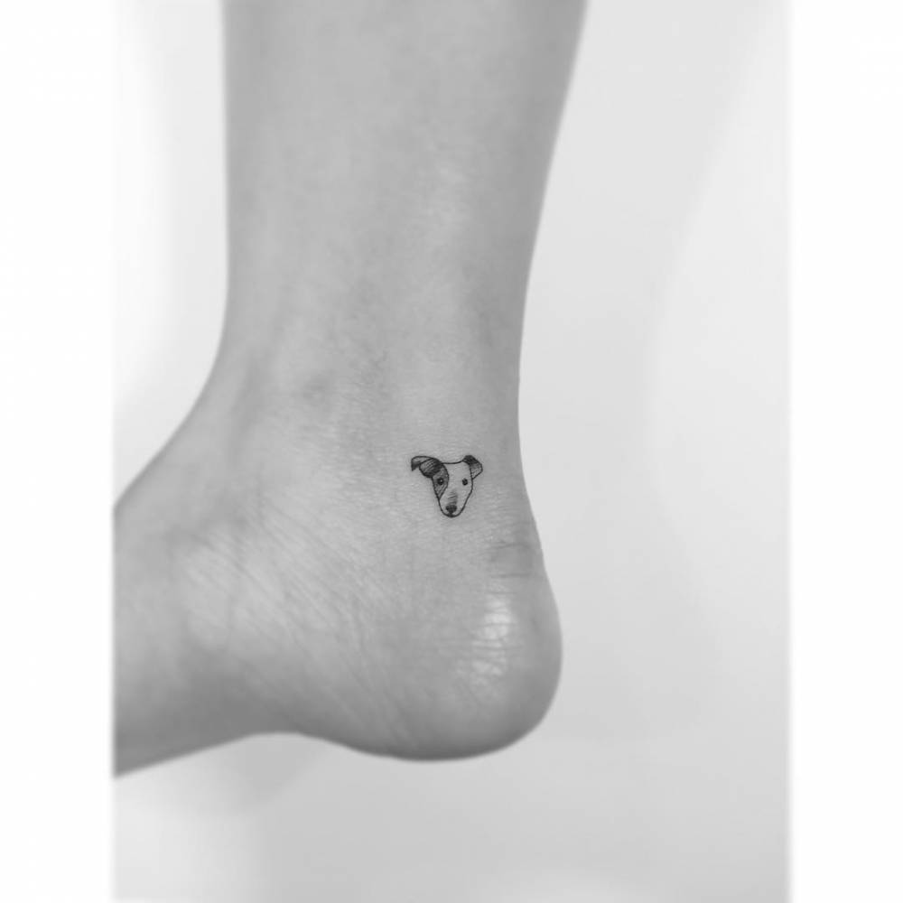 Jack Russell portrait tattoo located on the ankle, minimalistic style.
